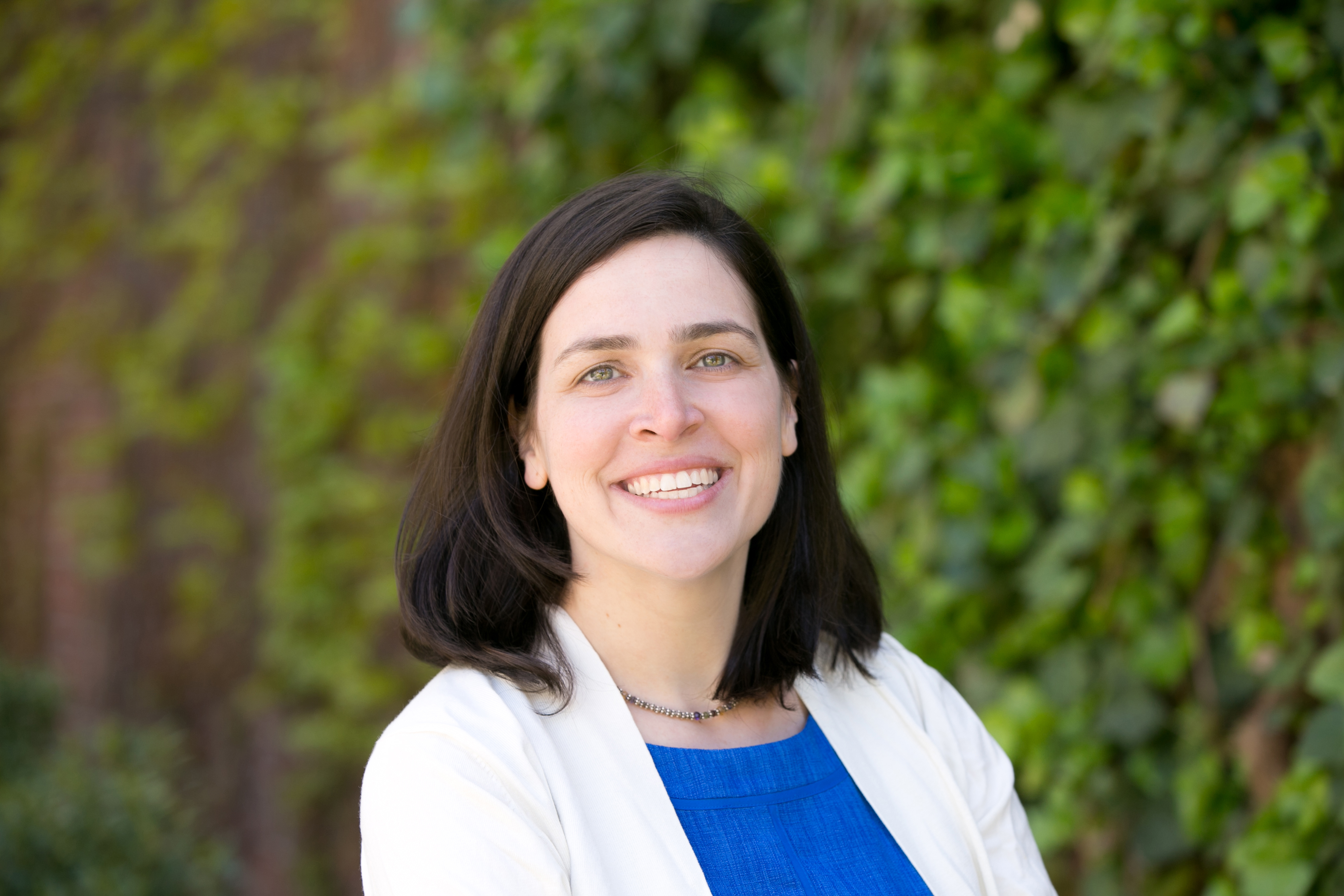 Headshot of Deborah smiling outside