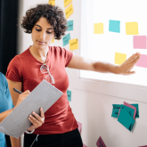 Two women working on solving a problem