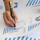 Hands of a person reviewing financial statements