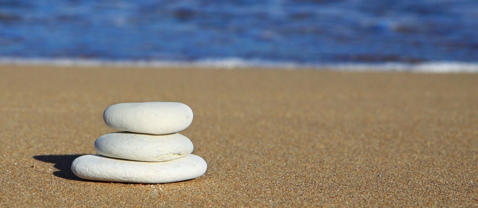 tower of three flat stones on a beach
