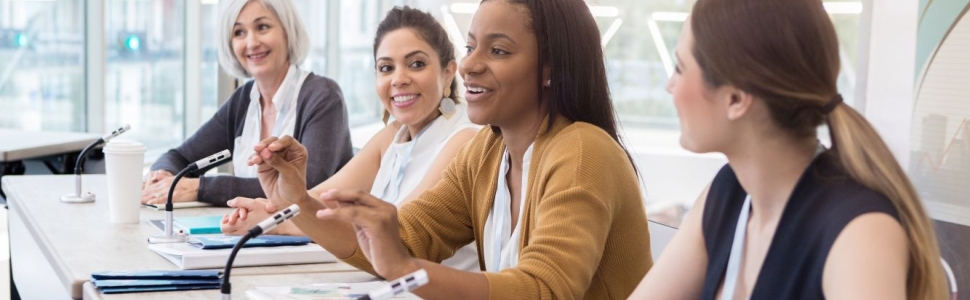 Diverse group of women sitting at a conference table