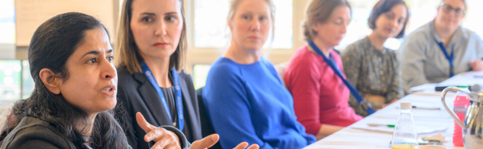 Six diverse women sitting in a leadership development training at Smith College