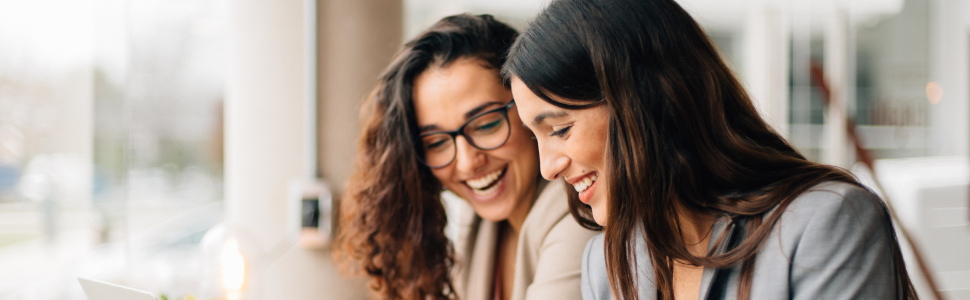 Two women collaborating during a live online leadership program.