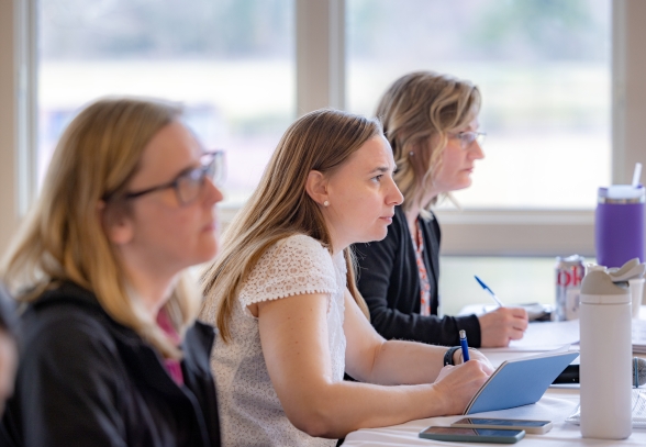 Three women leaders in STEM roles and fields are learning in an executive education program 