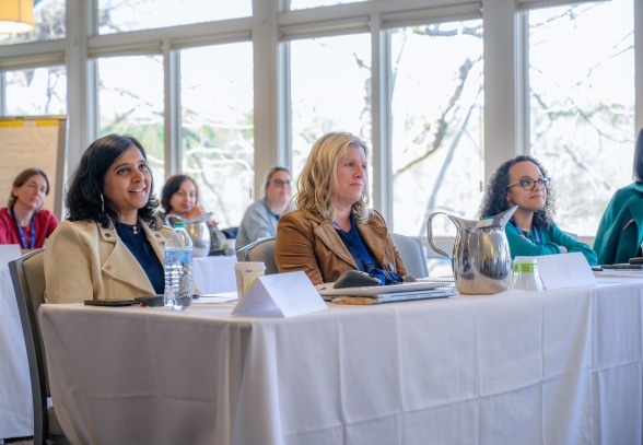 Three women learning in an executive education program.